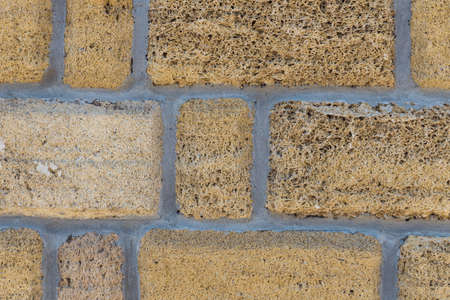 Background from natural foam concrete blocks. Texture of shell rock. Brick from the shell.の写真素材