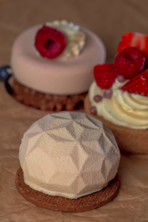 three delicious cakes with fruit on brown paper, large photoの写真素材