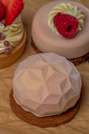 three delicious cakes with fruit on brown paper, large photoの写真素材