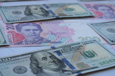 American one hundred dollars banknote and ukrainian hryvnasの写真素材