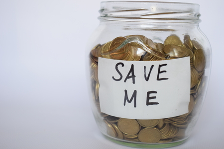 Save money, Coins in transparent bank on a light background, investment concept, coins in a piggyの写真素材