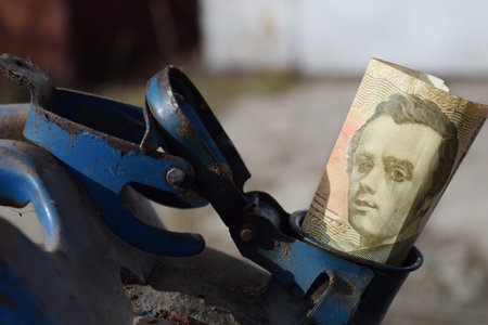 Metal barrel and Ukrainian money, the concept of the cost of gasoline, diesel, gas. Refilling the...