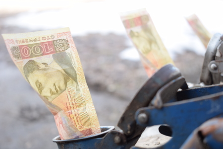Metal barrel and Ukrainian money, the concept of the cost of gasoline, diesel, gas. Refilling the car.の写真素材