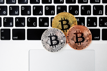 Gold currency bitcoin currency on keyboard laptop computer, electronic finance concept. Bitcoin coins.の写真素材