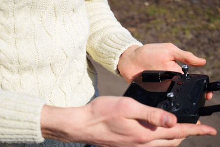 Remote control for quadrocopter, close-up. Transmitter for controlling moving device in male hands Electronics, hobby, aeromodelling conceptの写真素材