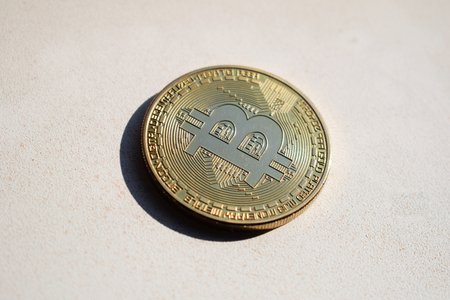 Physical Bitcoin BTC on a light background, finance concept.の写真素材