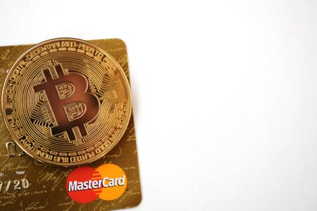 Bitcoin golden coin with MasterCard credit cards. White background.のeditorial素材