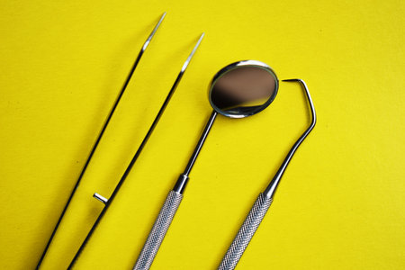 Tools for dental treatment on a yellow background. Prevention of diseases of the oral cavity. Dental Hygiene and Health conceptual image.の写真素材