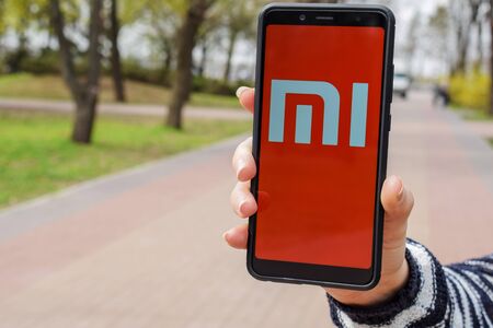 Ukraine, Kremenchug - April, 2019: Xiaomi MI logo on Smartphone Screen. Xiaomi is a popular manufacturer of technology.のeditorial素材
