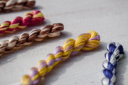 Multicolored braided floss threads for embroidery. Textile industry, thread, decoration