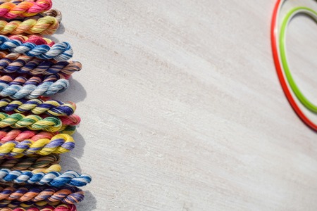 Embroidery hoops for creative art and braided floss threads for embroidery on a light background. Free text space. Creative concept.の写真素材