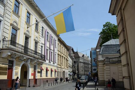 Ukraine, Lviv - May, 2019 Flag of Ukraine on pole on building wall in Lvivのeditorial素材