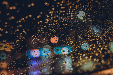 Abstract background from water drops on glass.の写真素材