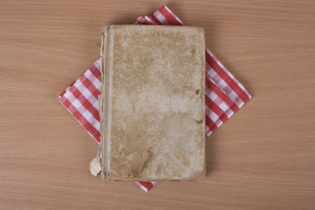 An old shabby light brown book on a bamboo stand, close-up top viewの写真素材