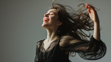 Beautiful lonely young woman celebrating with music and dance. Copy Space.の素材