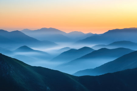 Mountain landscape in the fog at sunrise. View from the top of the mountain.の素材