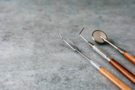 Dental tools and instruments on gray table, closeup. Space for textの素材