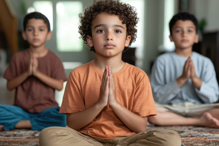 Portrait of a boy meditating with his friends in the backgroundの素材