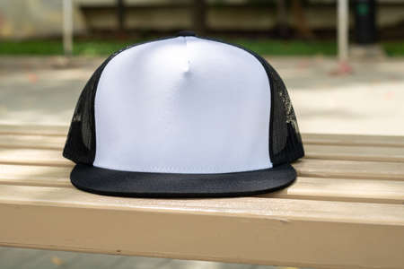 Blank trucker hat cap flat visor with black and white color in outdoor, ready for your mock up design or presentation your design projectの写真素材