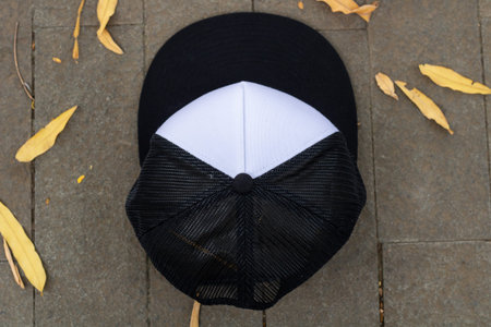 Blank trucker hat cap flat visor with black and white color in outdoor, ready for your mock up...