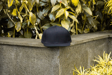 Blank snapback hat cap flat visor with black color in outdoor, ready for your mock up design or...