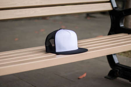 Blank trucker hat cap flat visor with black and white color in outdoor, ready for your mock up design or presentation your design projectの写真素材