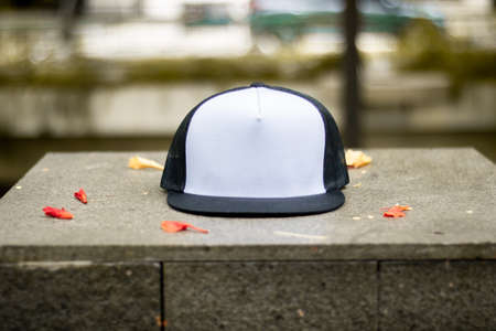 Blank trucker hat cap flat visor with black and white color in outdoor, ready for your mock up design or presentation your design projectの写真素材