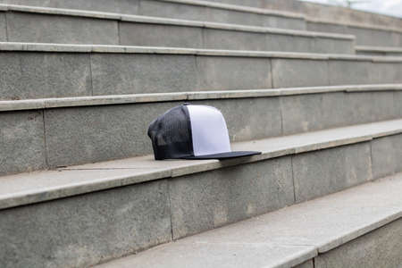 Blank trucker hat cap flat visor with black and white color in outdoor, ready for your mock up design or presentation your design projectの写真素材