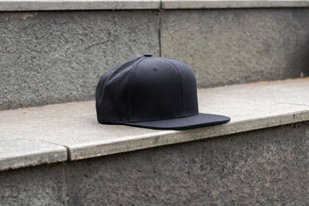 Blank snapback hat cap flat visor with black color in outdoor, ready for your mock up design or presentation your design projectの写真素材