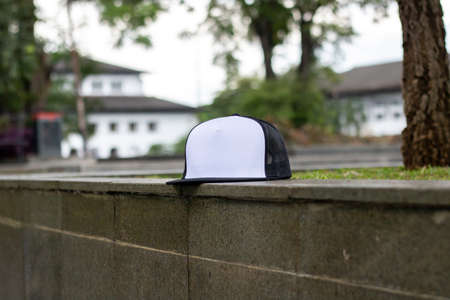 Blank trucker hat cap flat visor with black and white color in outdoor, ready for your mock up design or presentation your design projectの写真素材