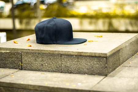 Blank snapback hat cap flat visor with black color in outdoor, ready for your mock up design or presentation your design projectの写真素材