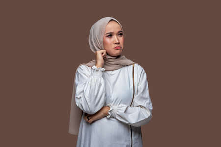 Young woman in hijab with sad, worried and disappointed expressionの写真素材
