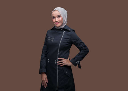 Pretty asian woman wearing hijab posing on plain backgroundの写真素材