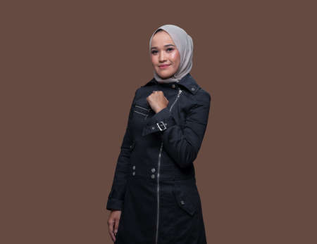 Beautiful hijab woman posing on plain background with smilingの写真素材