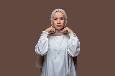 Woman wearing hijab posing crying and sad expression isolated on plain backgroundの写真素材