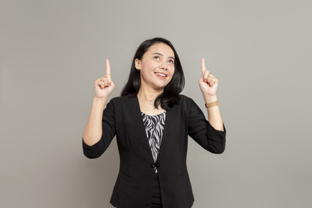 Shocked business woman holding and looking at laptop screenの写真素材