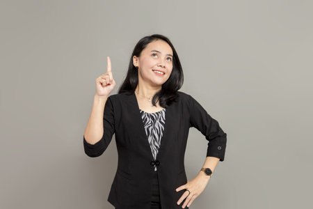 Business woman is imagining with pen on cheek while holding clipboard