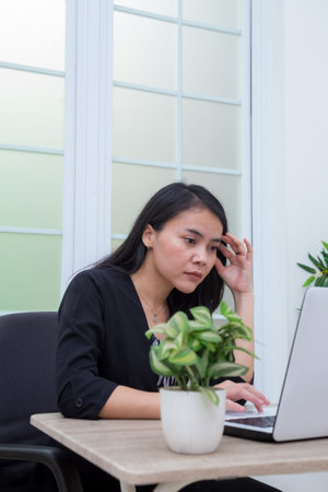 Business woman sitting on chair having online meeting using laptop