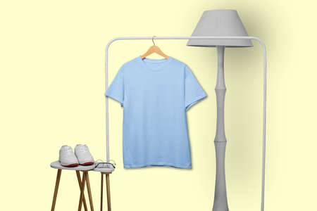 Blue t-shirt hanging on rack display isolated on plain backgroundの写真素材