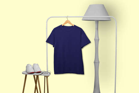 Navy t-shirt hanging on rack display isolated on plain backgroundの写真素材