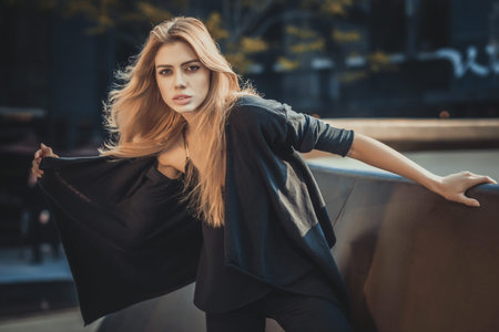 Beautiful young model woman posing in modern architecture environment. Fashion styleの写真素材