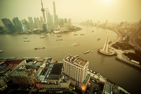 Panorama view of Shanghai city scape in fog at sunset time. Aerial