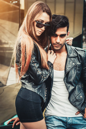 Young and trendy man and woman models pose of the modern street. Fashion Style