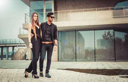Young trendy man and woman models walks of the modern street. Fashion Styleの写真素材
