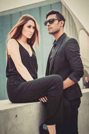 Young trendy man and woman models posing of the modern street. Fashion Styleの写真素材