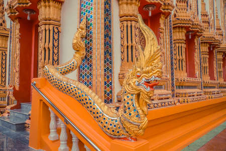Ancient Thai temple. Wat Kosit Wihan golden Temple Phuket, Thailand. Stairs entrance dragons.の写真素材