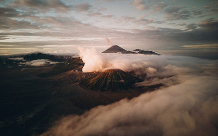 Landscape view of misty mount Bromo volcano. Foggy morning in the java national park with mount...