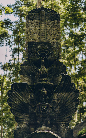 Close up shot of stone sculpture covered with moss in monkey forest. Traditional balinese architecture in ubud sanctuaryの写真素材