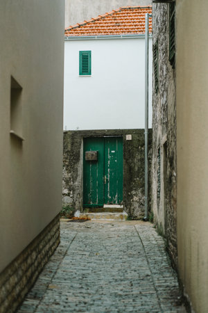 Old narrow street with house facades, entrance doors and retro mailbox, Old Town, Biograd na Moru in Croatiaの写真素材