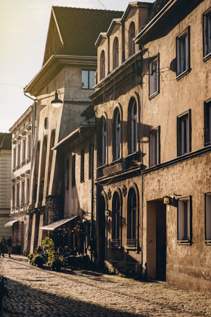 Old buildings facade, street cafe and courtyard in Krakow at sunset light, Polandの写真素材